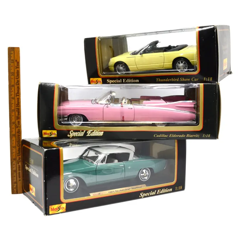Three 1:18 Maisto Diecast Classics – Pink Cadillac, Studebaker, and Thunderbird